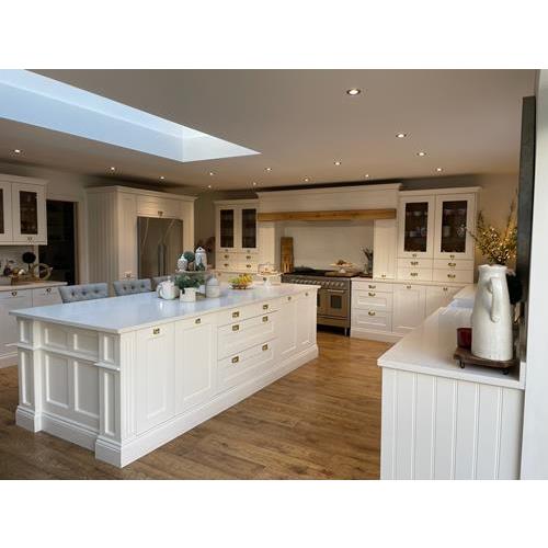 Fitted kitchen with large kitchen island white cabinets quartz worktops and roof light 500x500