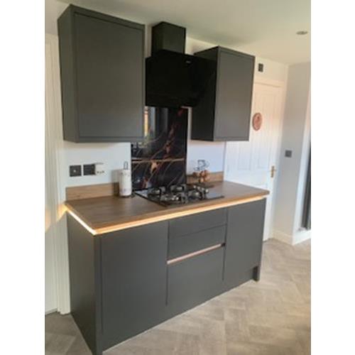 Fitted kitchen with modern grey cabinets built in hob wood laminate worktops and worktop edge lighting 500x500