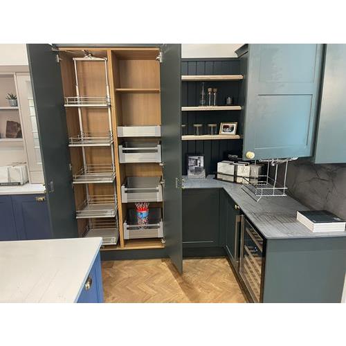 Grey fitted kitchen with cupboard doors open to show storage options 500x500