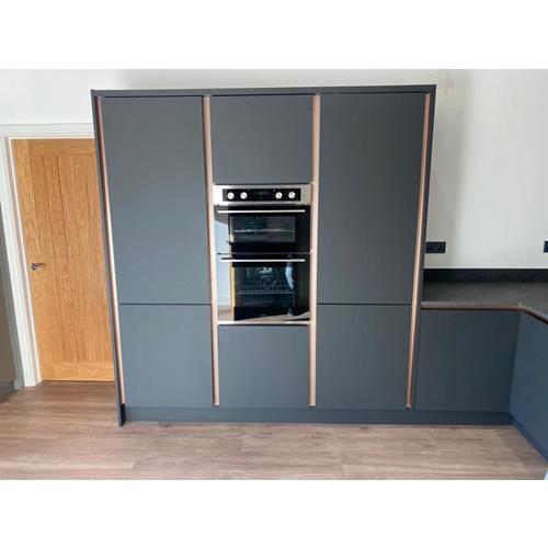 Modern grey fitted full height kitchen cabinets with copper trim and built in oven 500x500